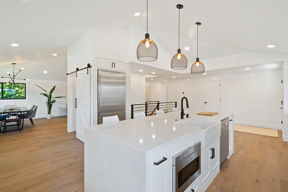 a modern kitchen with hanging lights